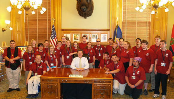 The 2012 Kansas YLF delegates pose for a picture with Governor Sam Brownback at the State Capital.
